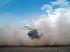 A Royal Air Force Merlin helicopter landing in dusty conditions